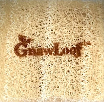 Reverse surface of a loofah waffle biscuit marked GnawLoof™