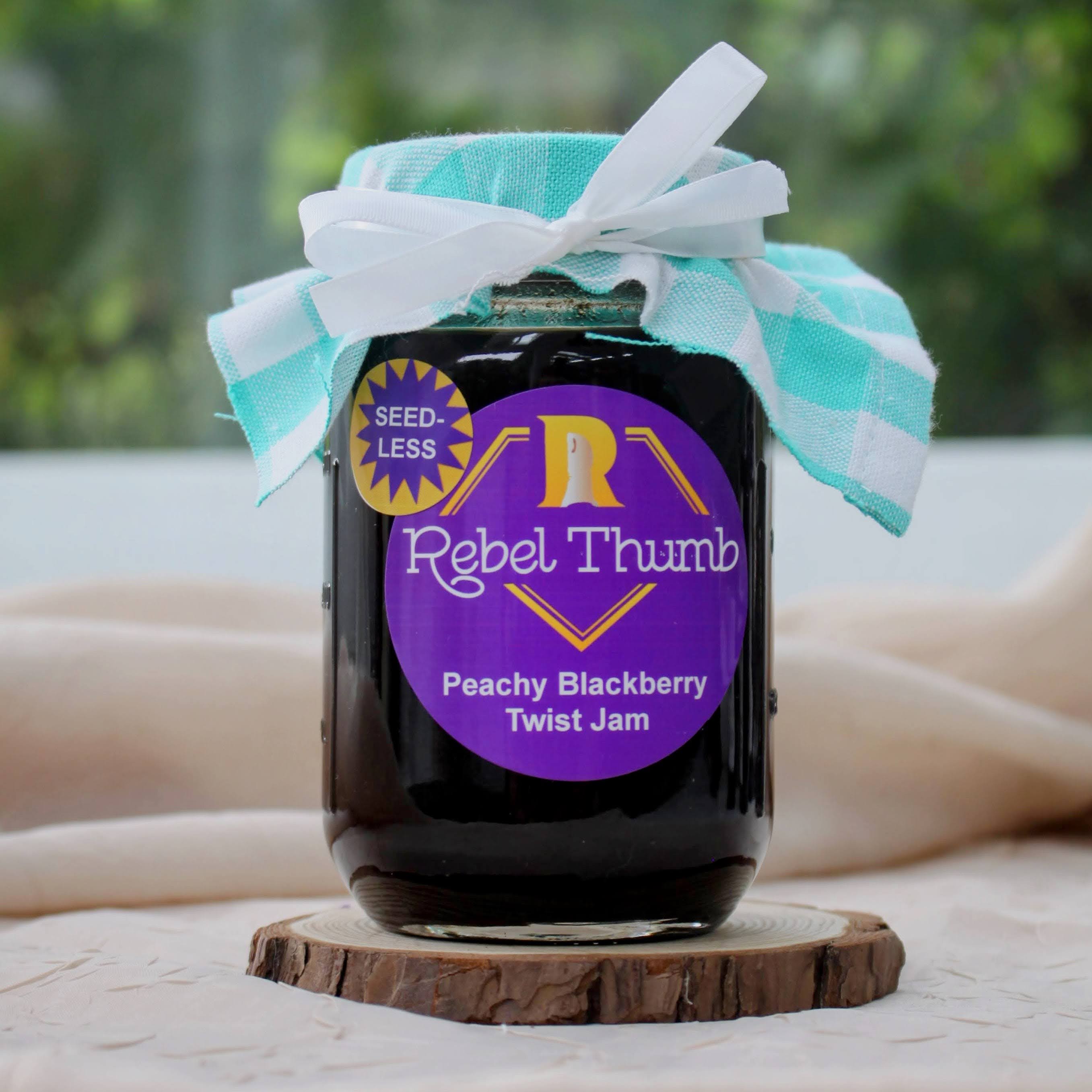 Jar of organic Rebel Thumb seedless Peachy Blackberry Twist Jam made in California