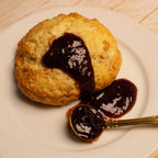 Scone with spoonful of Rebel Thumb organic jam made in California