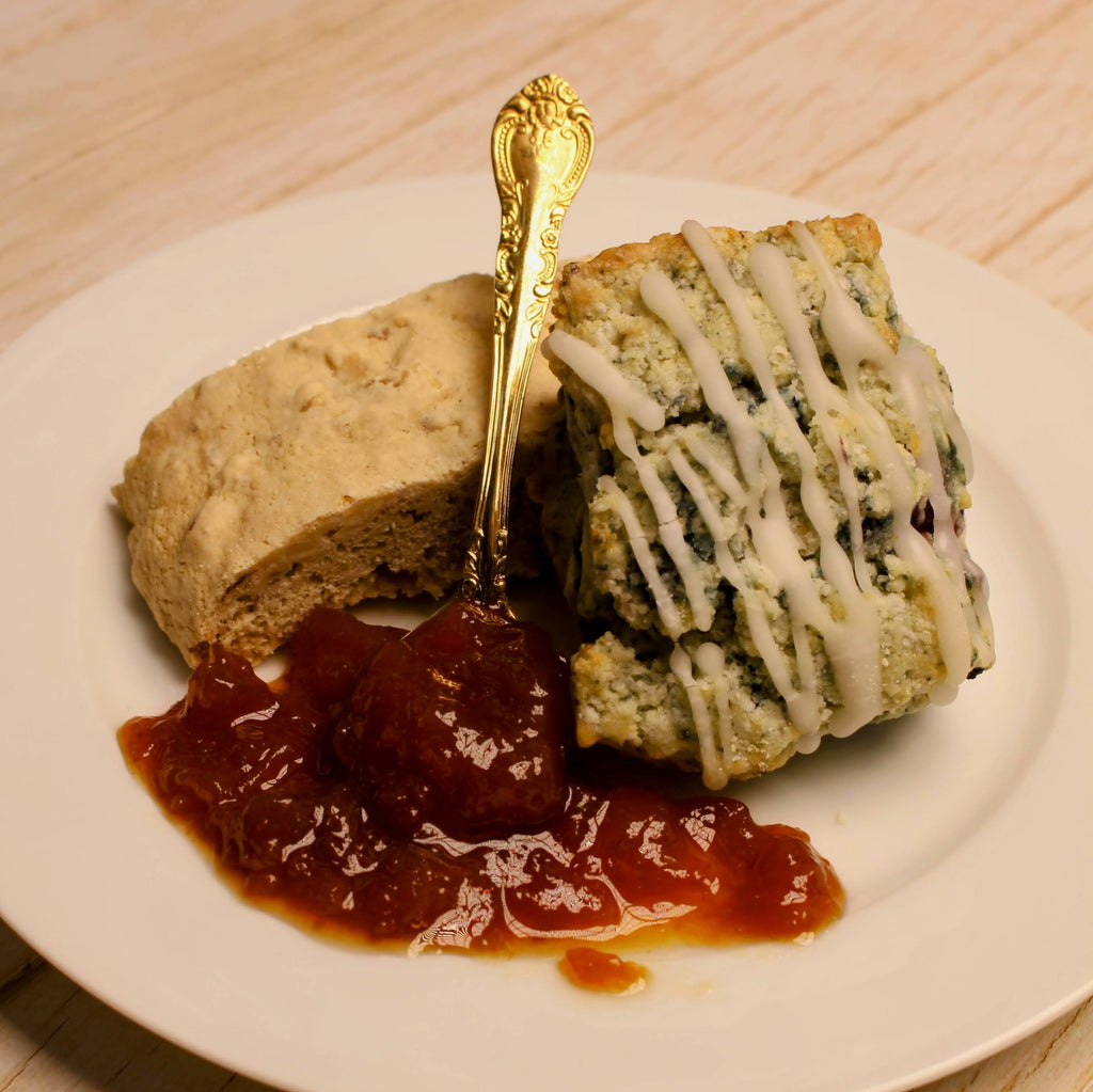 Two pieces of desserts with a spoonful of California made organic jam on a white plate.