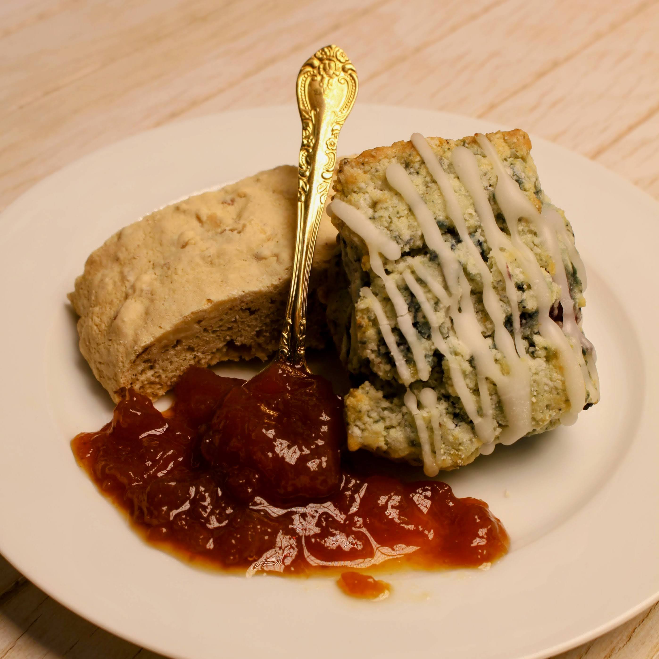 Two pieces of desserts with a spoonful of California made organic jam on a white plate.