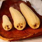 Sustainable and eco-friendly natural whole loofah (luffa) sponges for selfcare on a wooden surface
