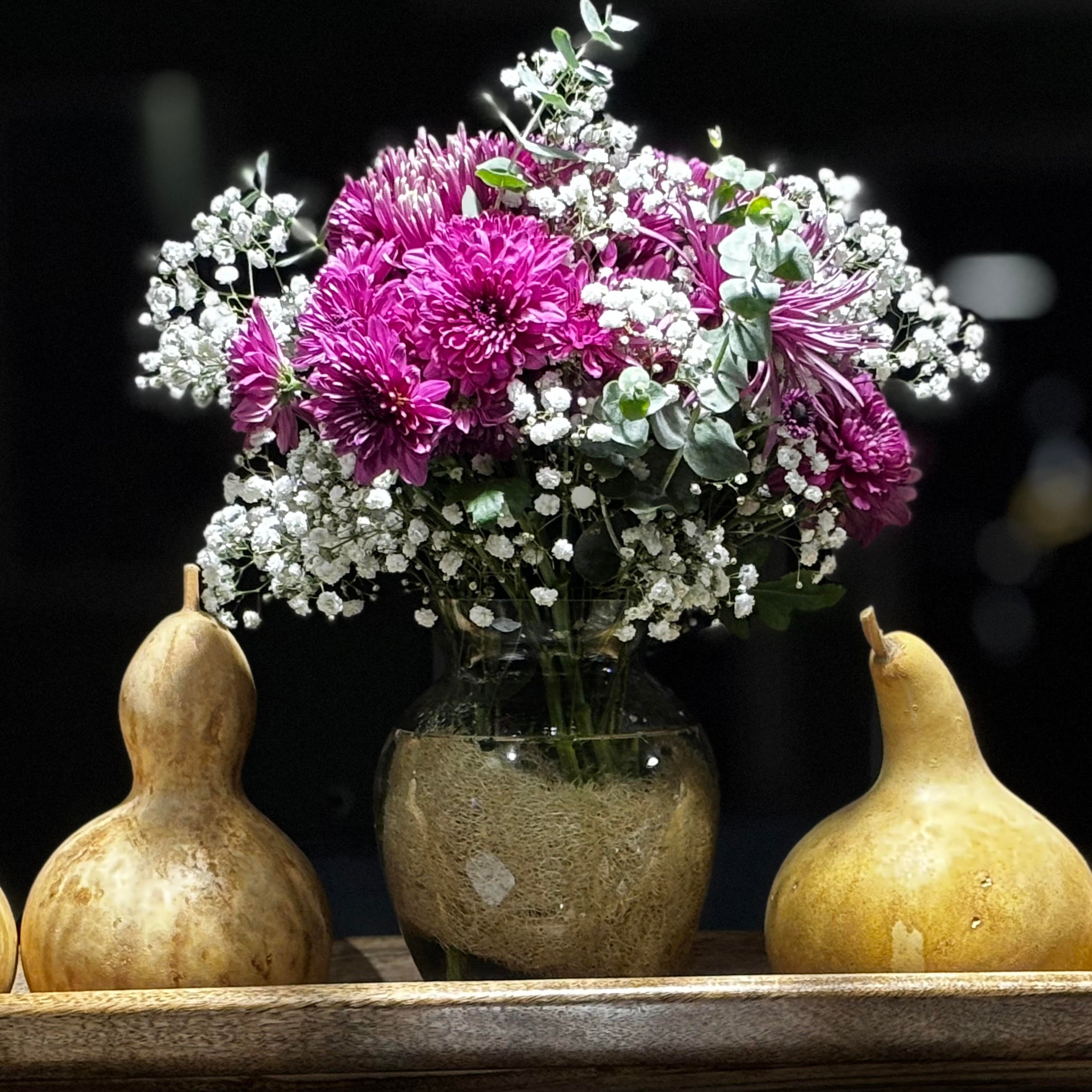 Vase filled with flowers and loofah (luffa) loose pieces inside